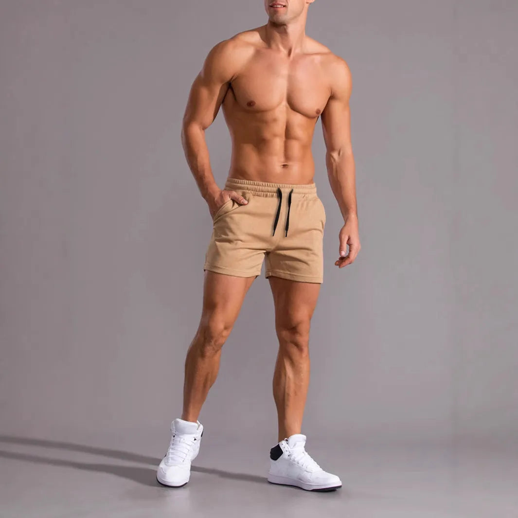 Three pairs of men's solid colour casual shorts with drawstring waistbands, shown in black, khaki, and light brown.
