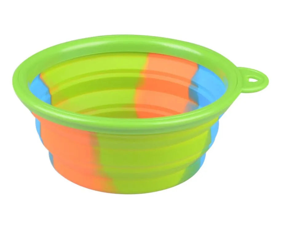 Collapsible silicone dog bowl in camouflage pattern folded flat on green surface