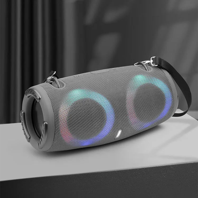 War Drum portable Bluetooth speaker with coloured LED lights in a black finish, showing carrying strap and control buttons.