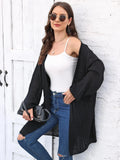 Women's loose fit acrylic sweater coat cardigan in a solid colour on a hanger.