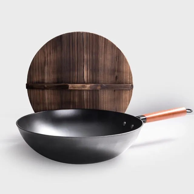 Traditional black iron wok with a long wooden handle, shown with a glass lid.