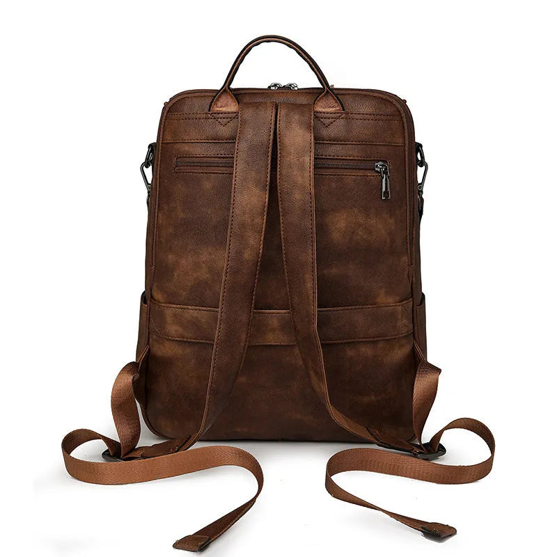 PU leather college backpack with curved shoulder strap in solid colour with stitching detail.