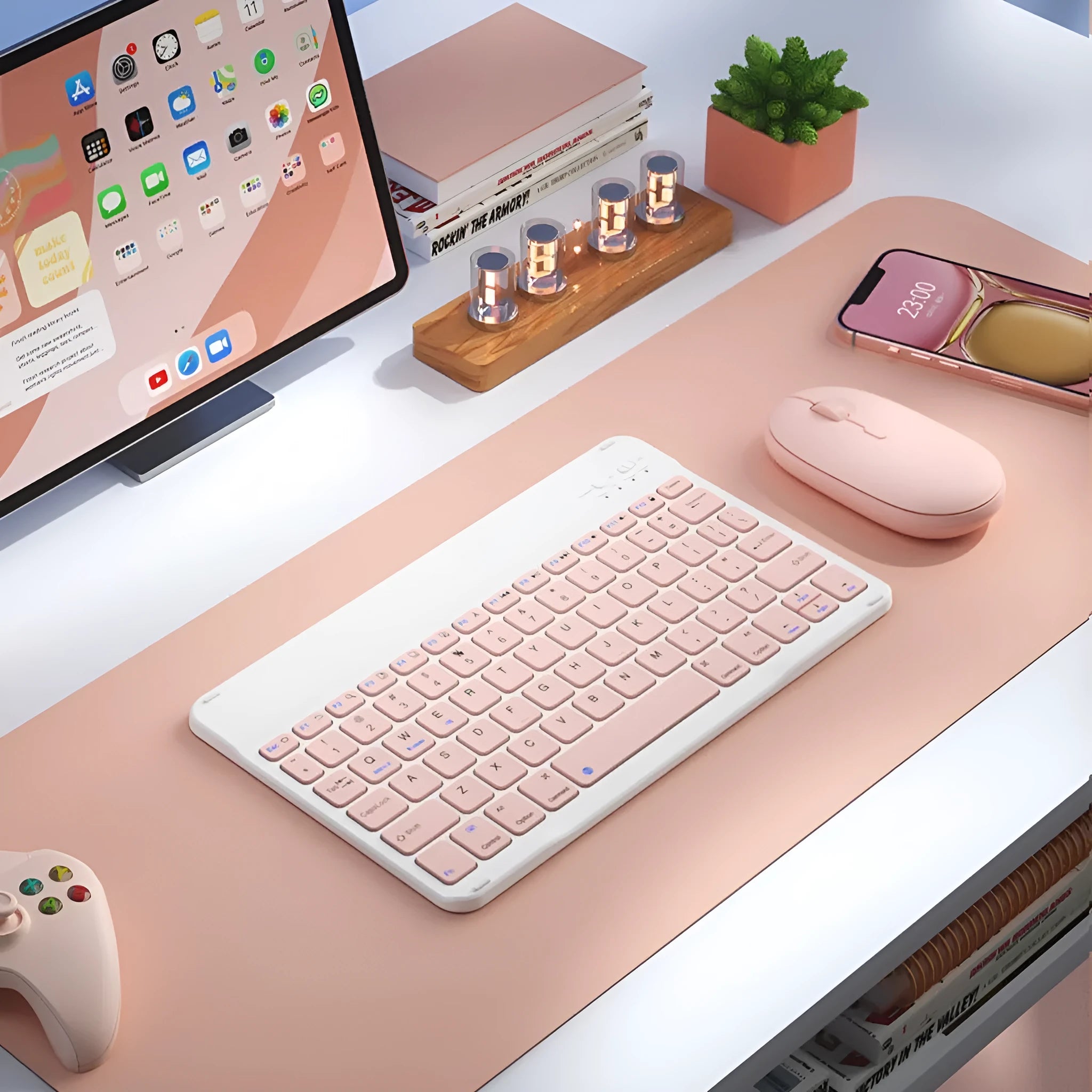 Bluetooth keyboard and matching rechargeable mouse set in elegant pink colour on a desk next to a tablet.