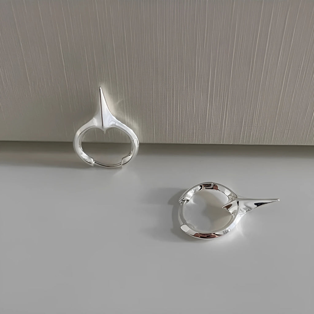 Women's geometric star-shaped clip earrings with a platinum electroplated finish on copper.