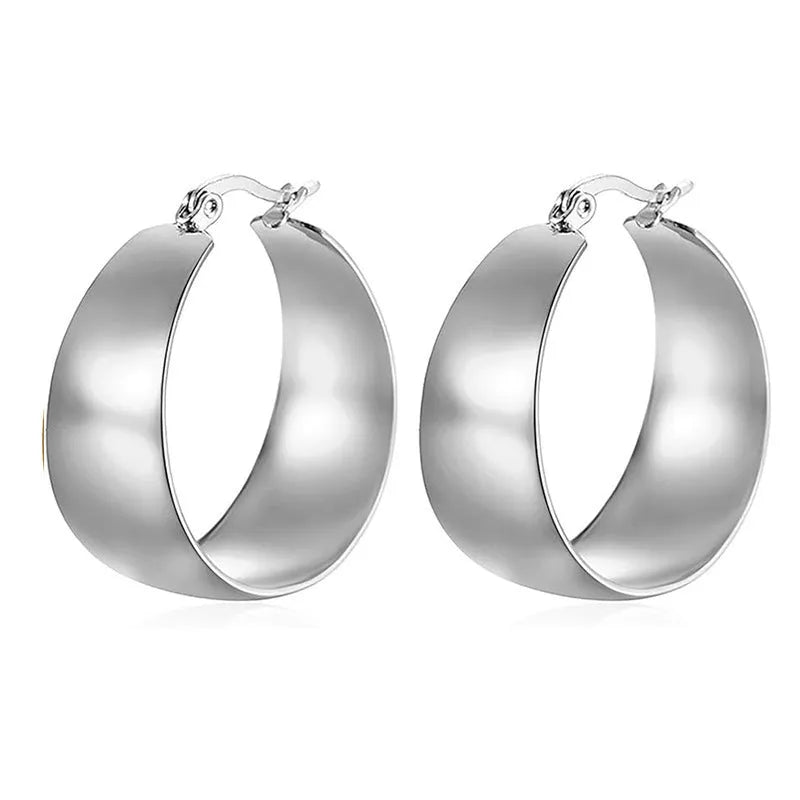 Widened curved stainless steel earrings with titanium construction in gold or steel colour, 25mm or 30mm diameter