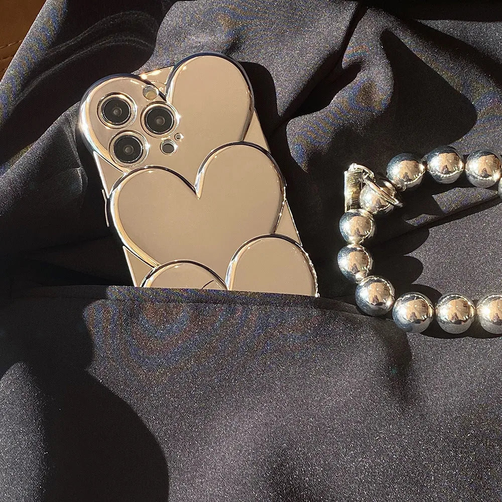 Flexible TPU iPhone case with a silver electroplated three-dimensional love design on the back.