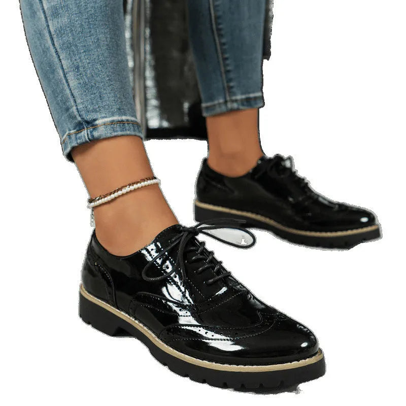 Women's black lace-up Oxford loafers with a wedge heel and sequin detail on the upper.