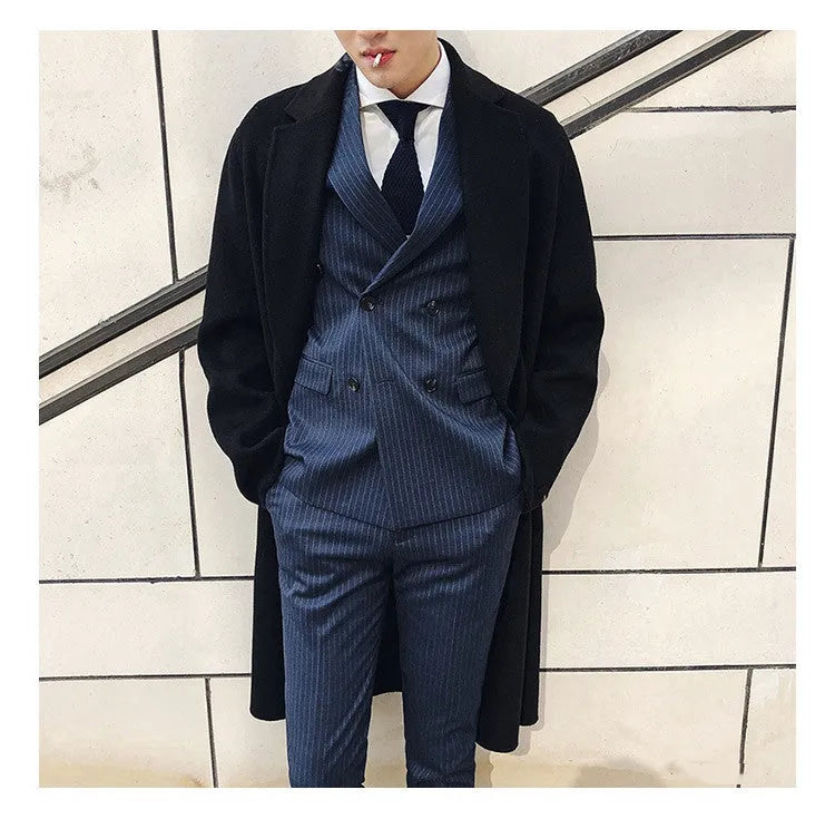 Men's black three-piece suit set with jacket, vest, and trousers, slim fit, anti-wrinkle fabric, on a mannequin.