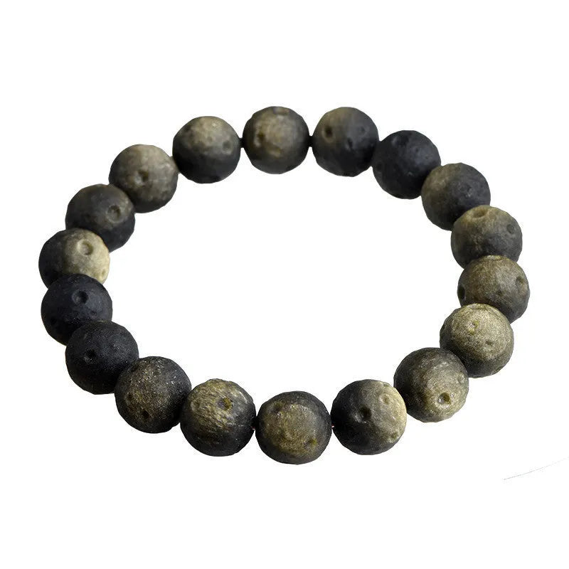 Natural obsidian crater ball bracelet in silver or gold finish, showing textured bead detail.