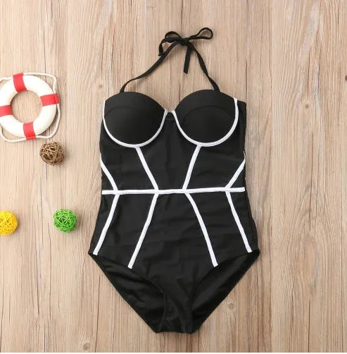 Black one-piece swimsuit shown in sizes S, M, L, and XL for swimming and beach use