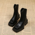 Black platform Martin boots for women with a square toe and back zipper.