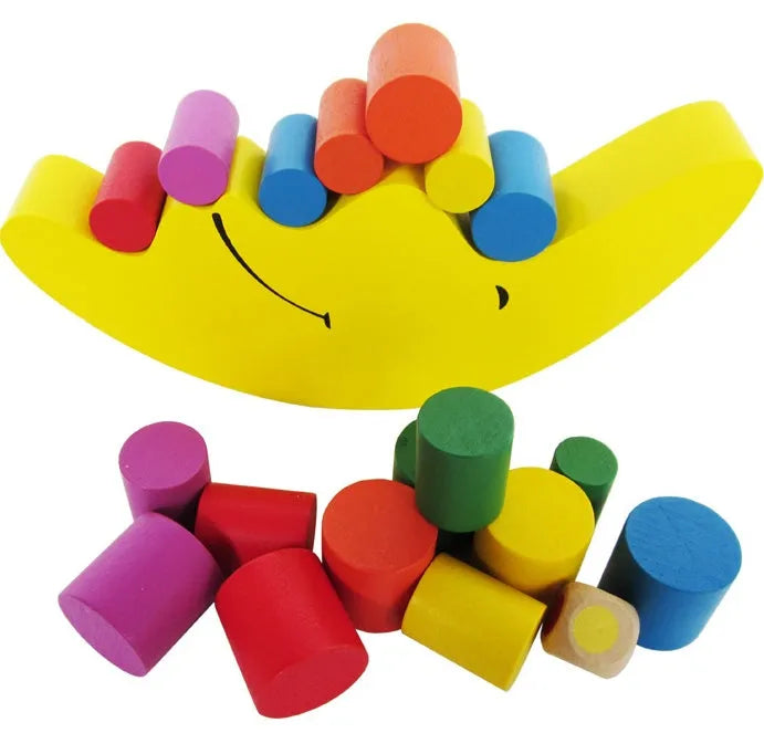 Yellow and blue moon-themed wooden balance game toy for toddlers on a white background.