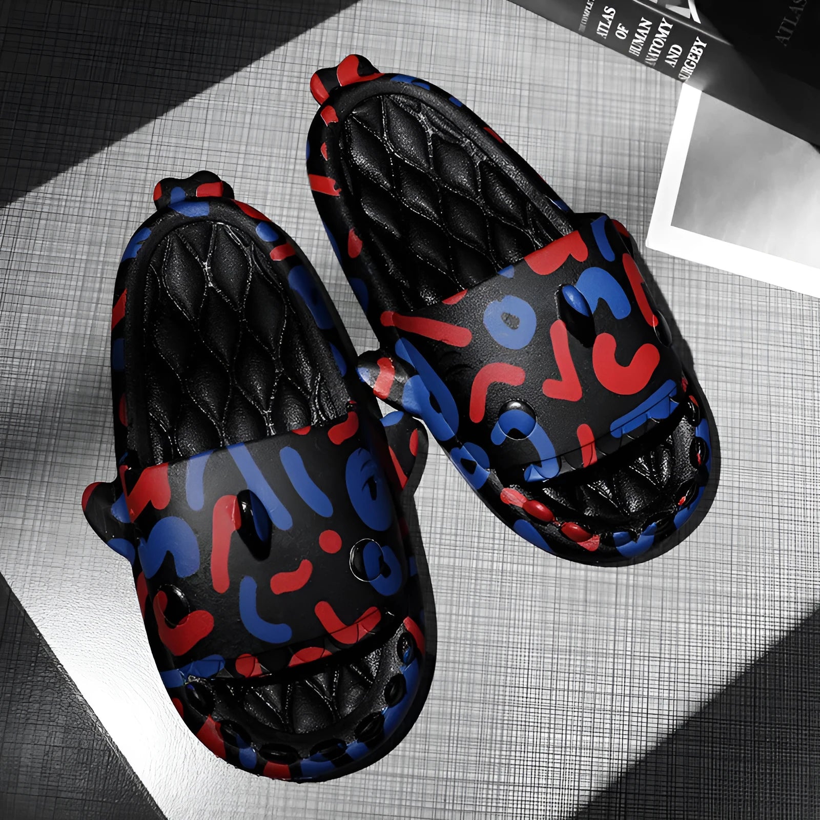 Pair of open-toe EVA home slippers with a shark design on a white background.