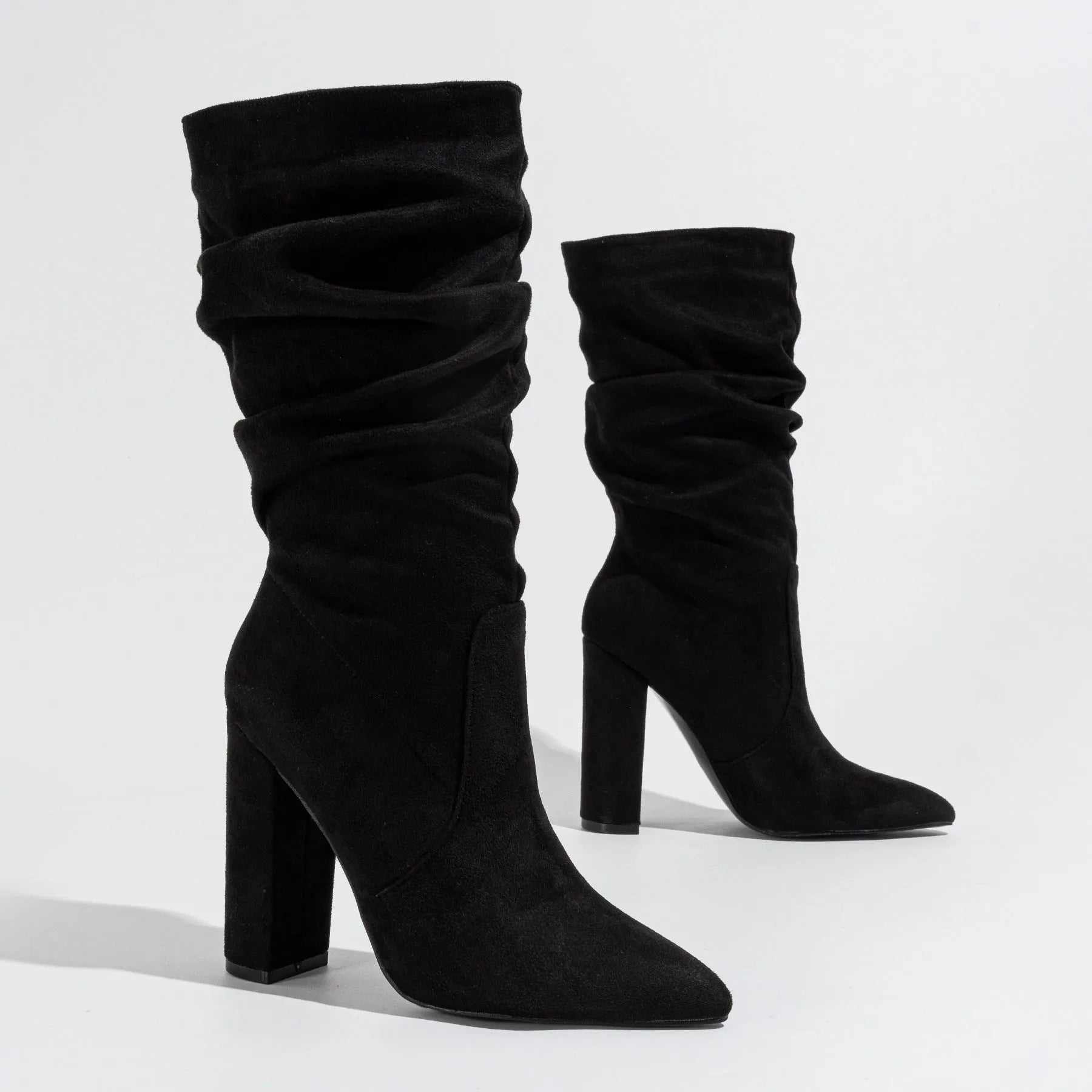 Women's black suede high heel boots with a chunky heel and pointed toe, mid-calf length.