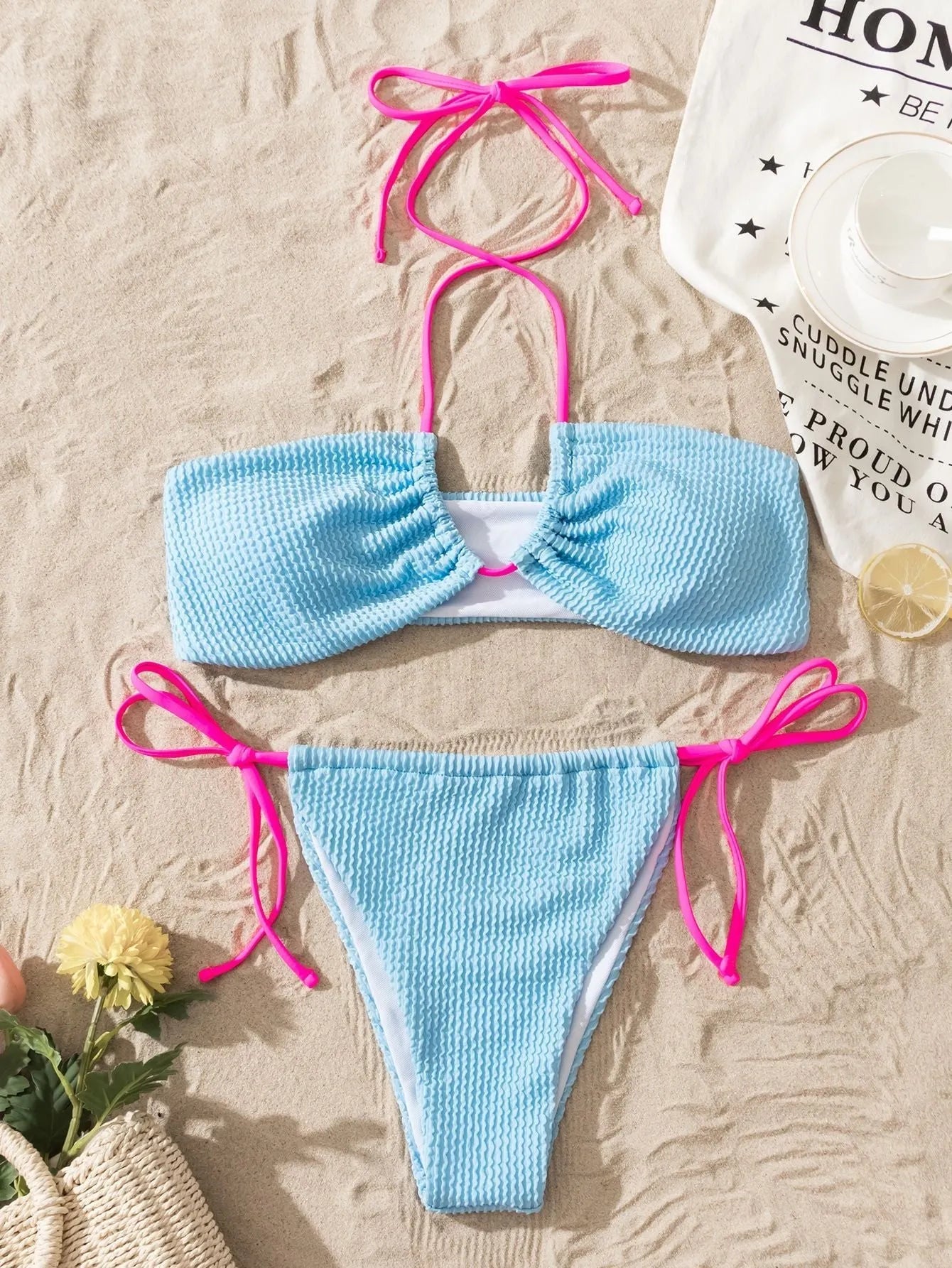 Solid colour women's two-piece swimsuit with lace-up halter top and briefs.