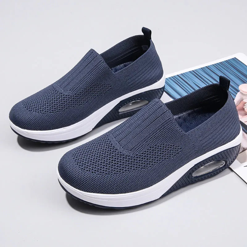 Women's casual running shoes with mesh and PU upper in beige, showing round toe and mid-heel design.