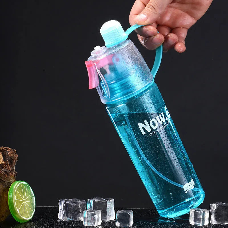 Green portable sports mist spray cup with handle, leakproof lid, and visible scale, shown next to a black version.