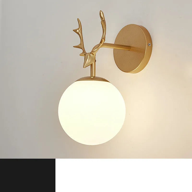 Round minimalist glass wall sconce with E27 bulb holder, shown in a black and golden finish, mounted on a plain wall.