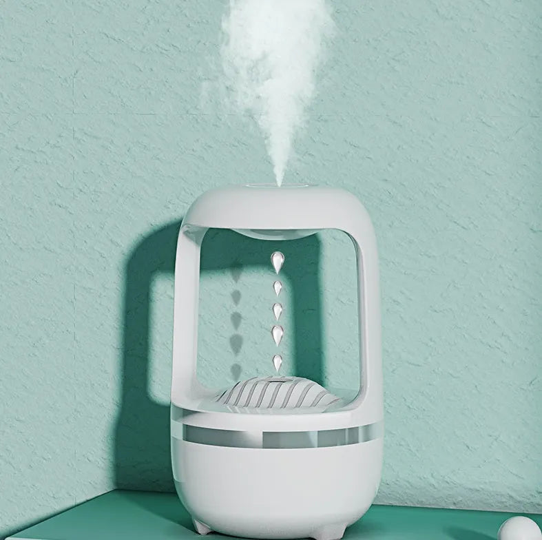 White anti-gravity humidifier showing water droplets flowing upwards, with USB cable and 500ml water tank.