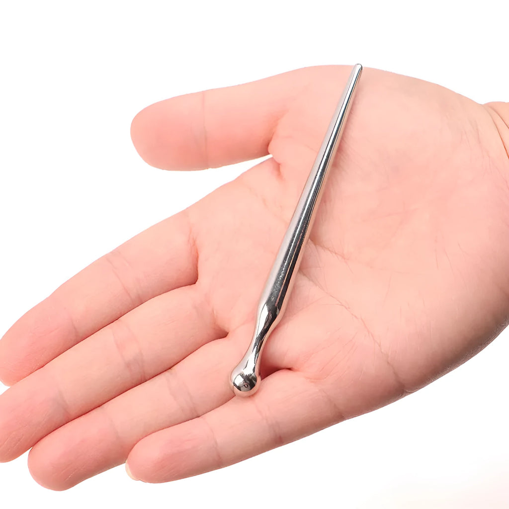 Silver metal urethral stimulation stick with round beads on a plain background