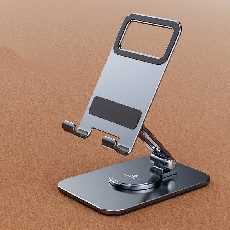 Rotary folding aluminium alloy desktop mobile phone stand in silver on a wooden table