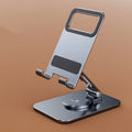 Rotary folding aluminium alloy desktop mobile phone stand in silver on a wooden table