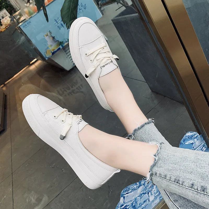 Women's casual lace-up shoes in white with round toe and rubber sole, side view