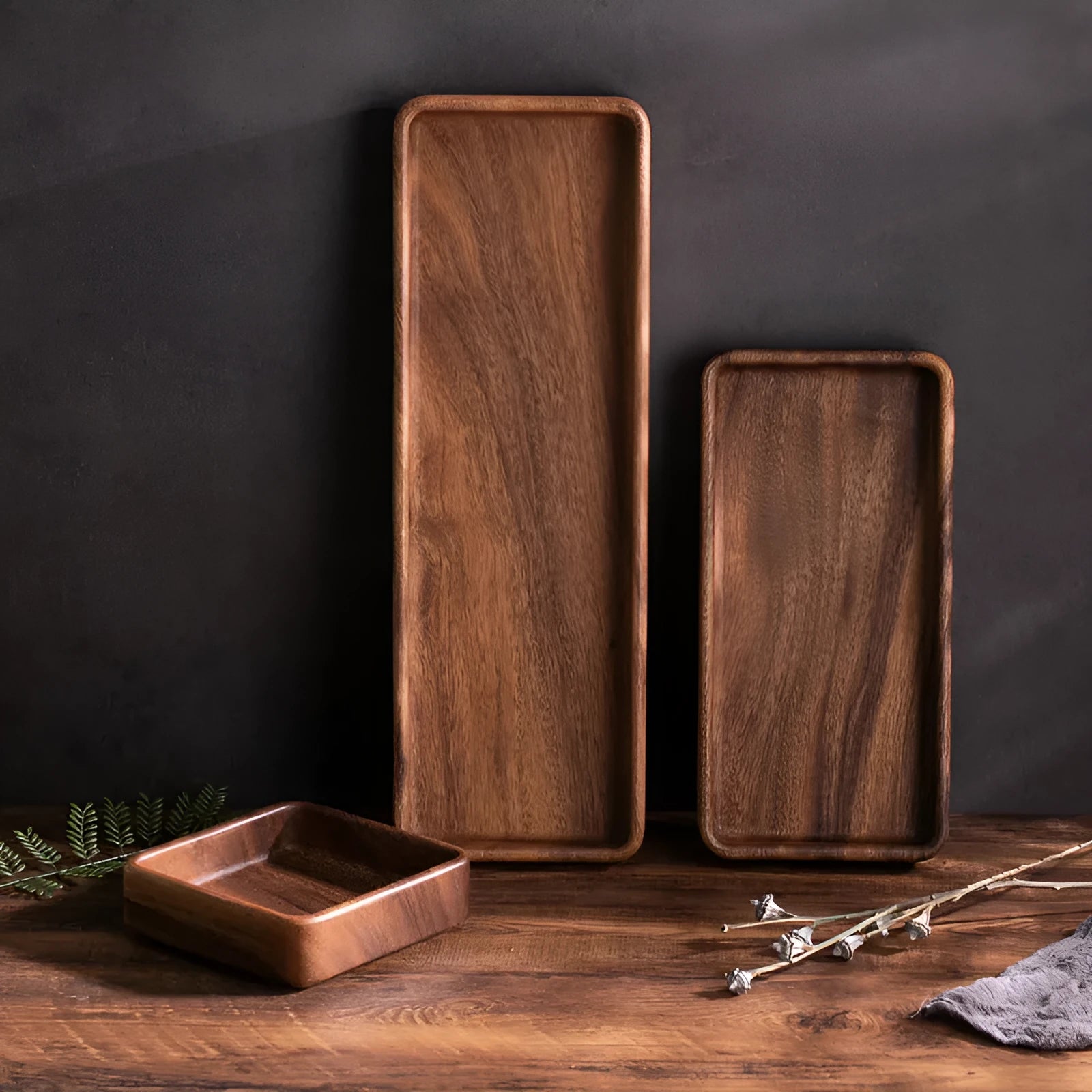Walnut wooden fruit plate tray in rectangular size on a table surface.
