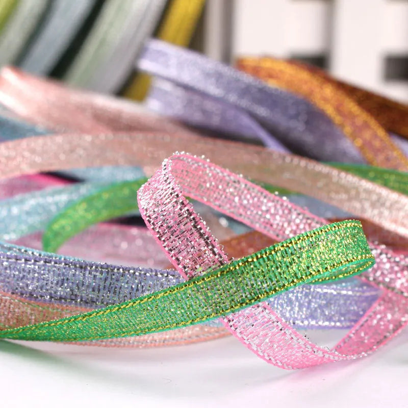 Roll of narrow 0.6cm wide polyester gift ribbon in a choice of colours including metallic gold and silver.