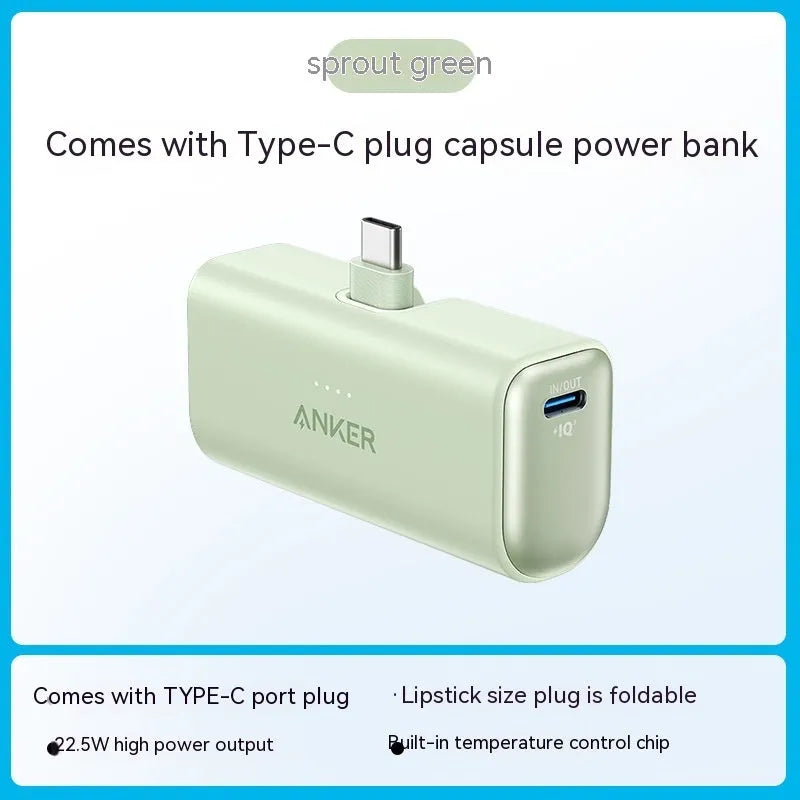 Small capsule-shaped power bank in multiple colours showing built-in foldable USB-C cable and compact size.