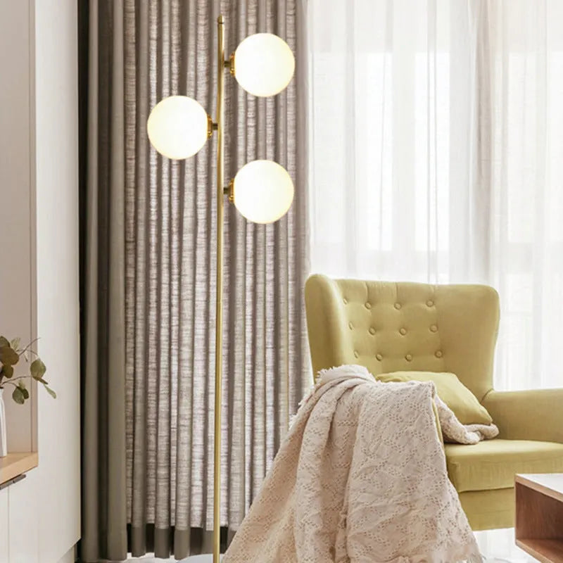 Creative minimalist floor lamp with warm LED light, gold aluminium alloy frame and glass shade