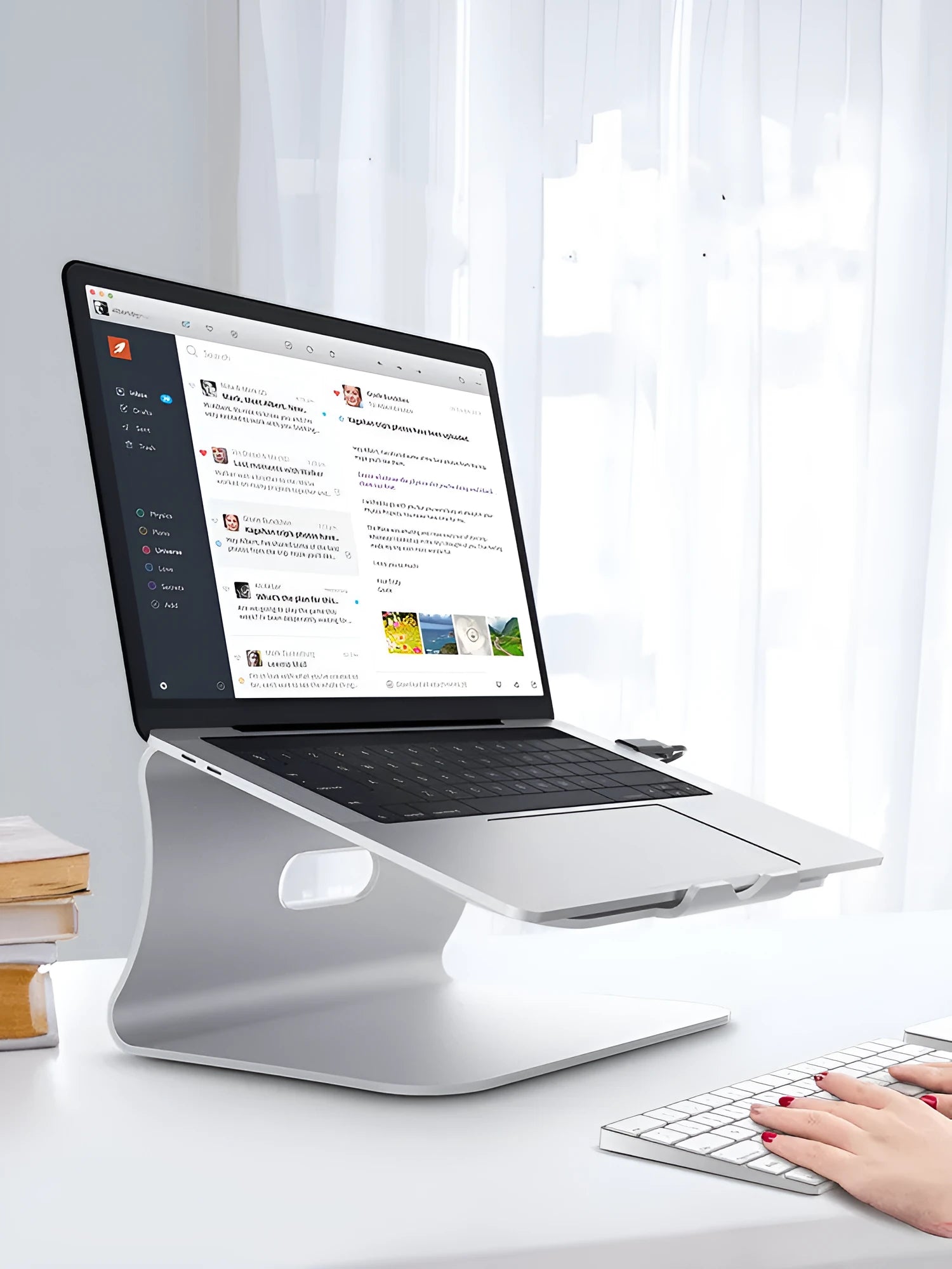 Silver aluminium laptop cooling bracket with rotary base on a wooden desk