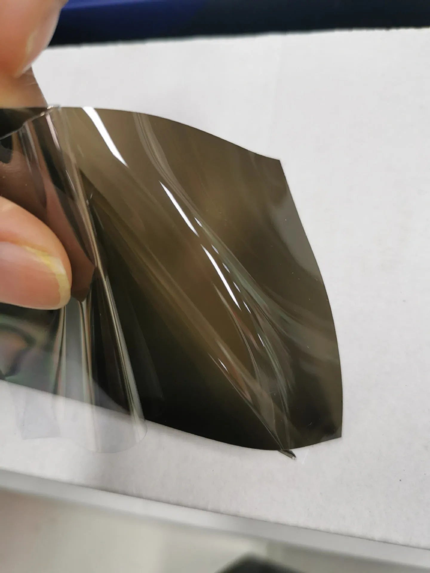 Roll of 30cm wide dark grey TPU protective film for car LED lamp protection.