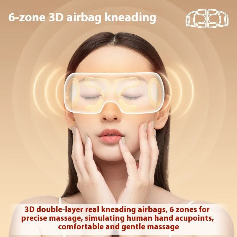 White rechargeable eye massager with hot compress and airbag massage functions on a flat surface