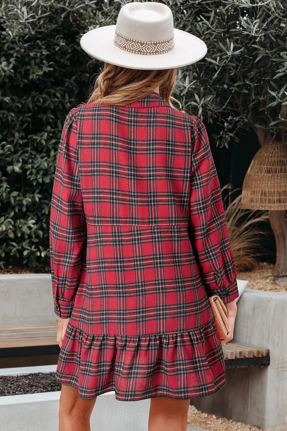 Red plaid mini dress with shirt collar, half-button front, long sleeves, and ruffle hem detailing