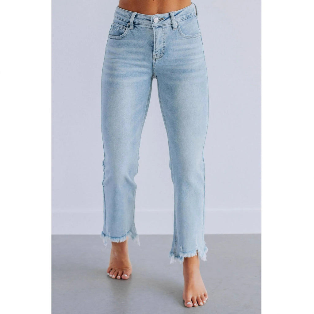 Women's solid colour denim jeans in dark blue showing hand-worn texture and casual fit.