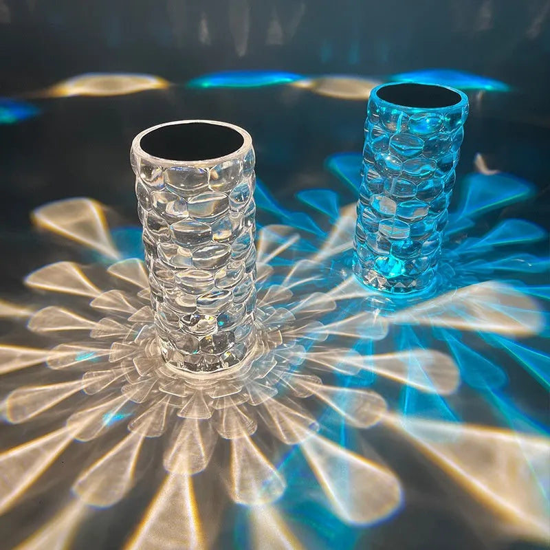 Crystal table lamp rechargeable with teardrop acrylic shade showing droplet shadow effect on a bedside table