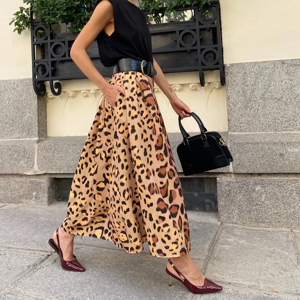 Brown leopard print women's long A-line skirt with a full hem on a hanger