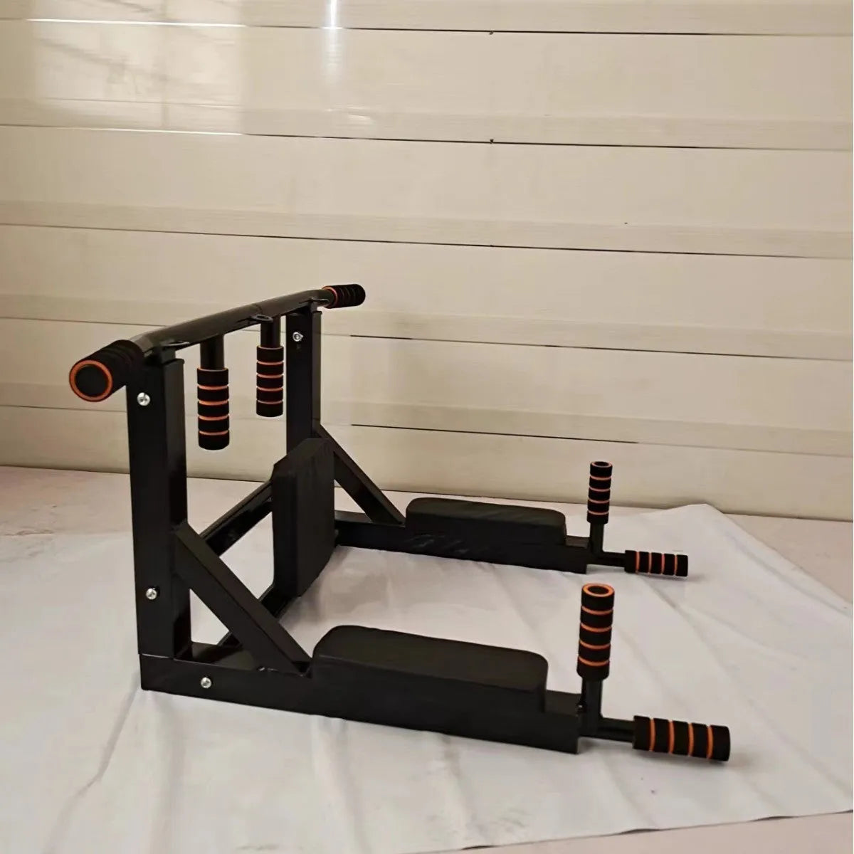 Black wall-mounted steel fitness equipment with parallel bars and a sandbag rack mounting point.