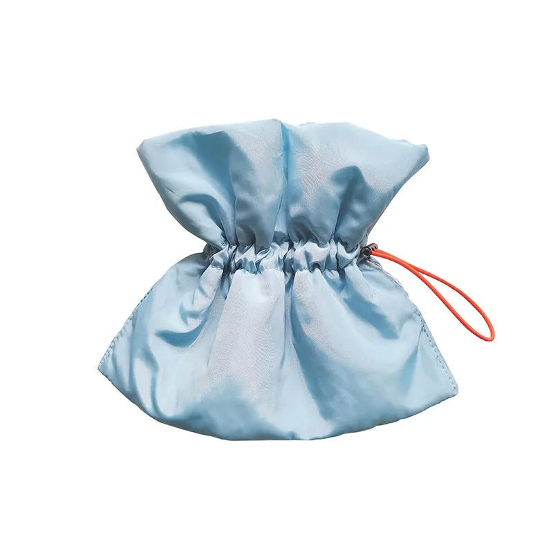 Soft light blue adjustable polyester cat recovery collar with elastic buckle on a flat surface.
