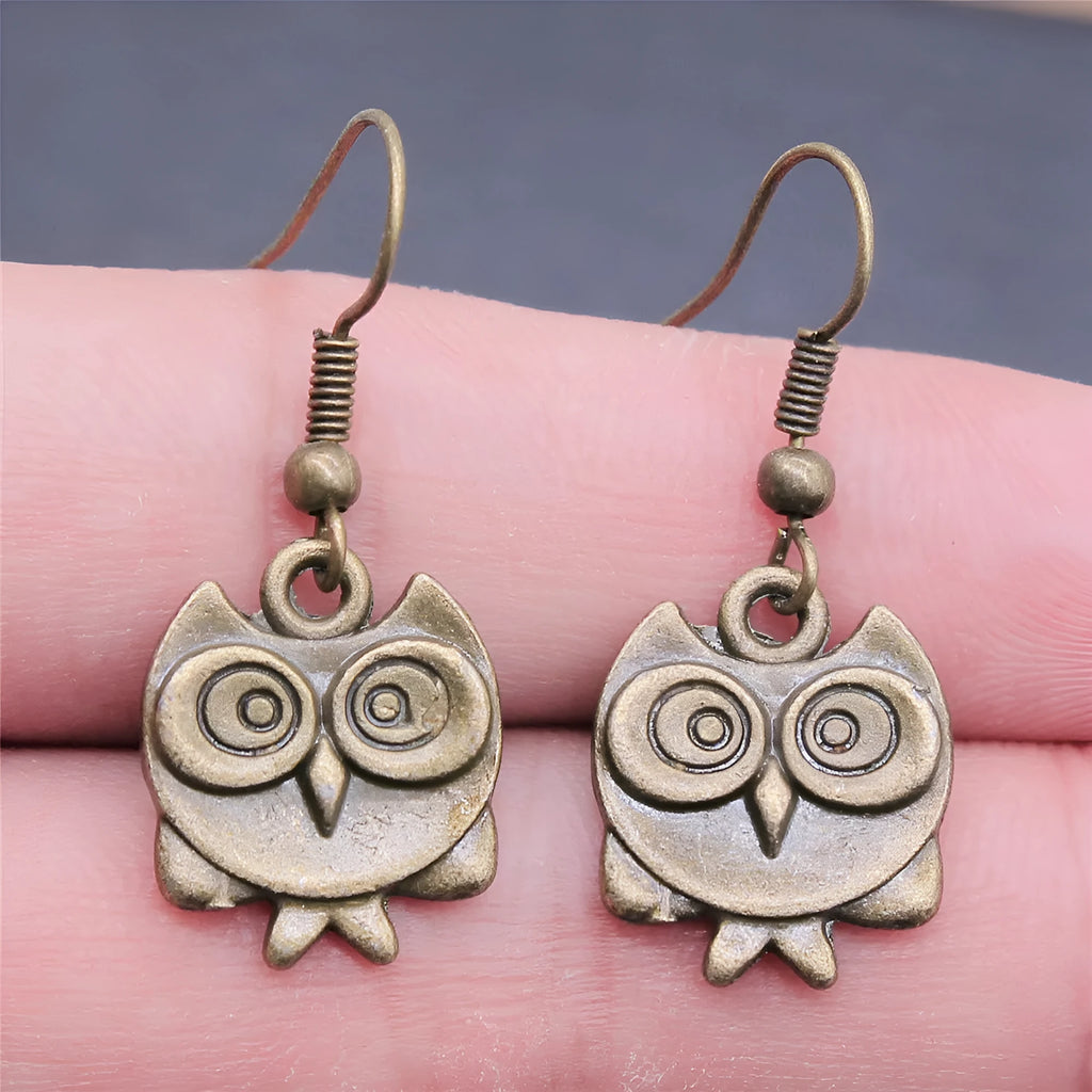 Retro double-sided owl earrings in antique bronze made of zinc alloy with iron ear hooks on a white background