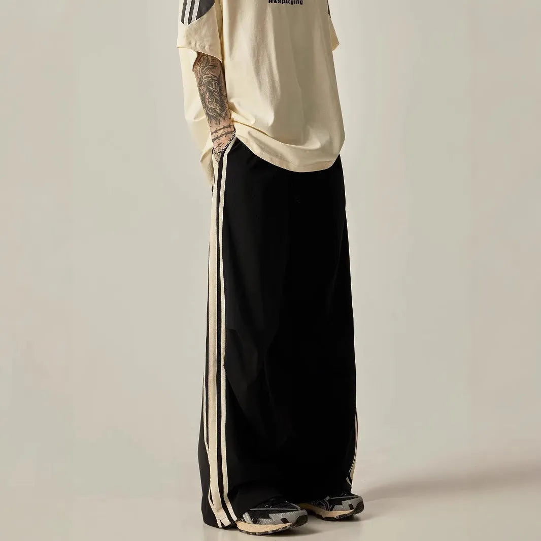 Black men's wide-leg high-waist climbing trousers laid flat, showing straight-leg cut.