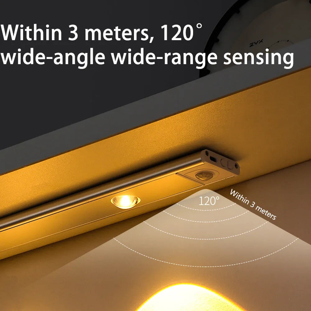 Silver ultra-thin wireless LED strip light with motion sensor attached to a kitchen cabinet door.