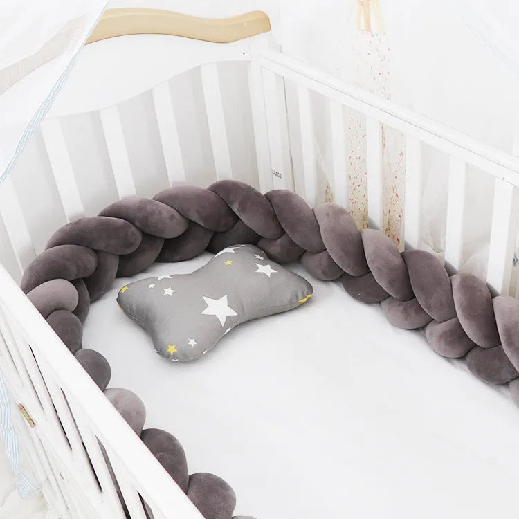 Long, flexible baby crib bumper pillow in spandex velvet, shown fitted around a white cot for safety protection.