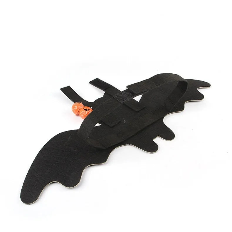 Halloween costume for a cat shaped like black bat wings, shown in orange pumpkin variant.