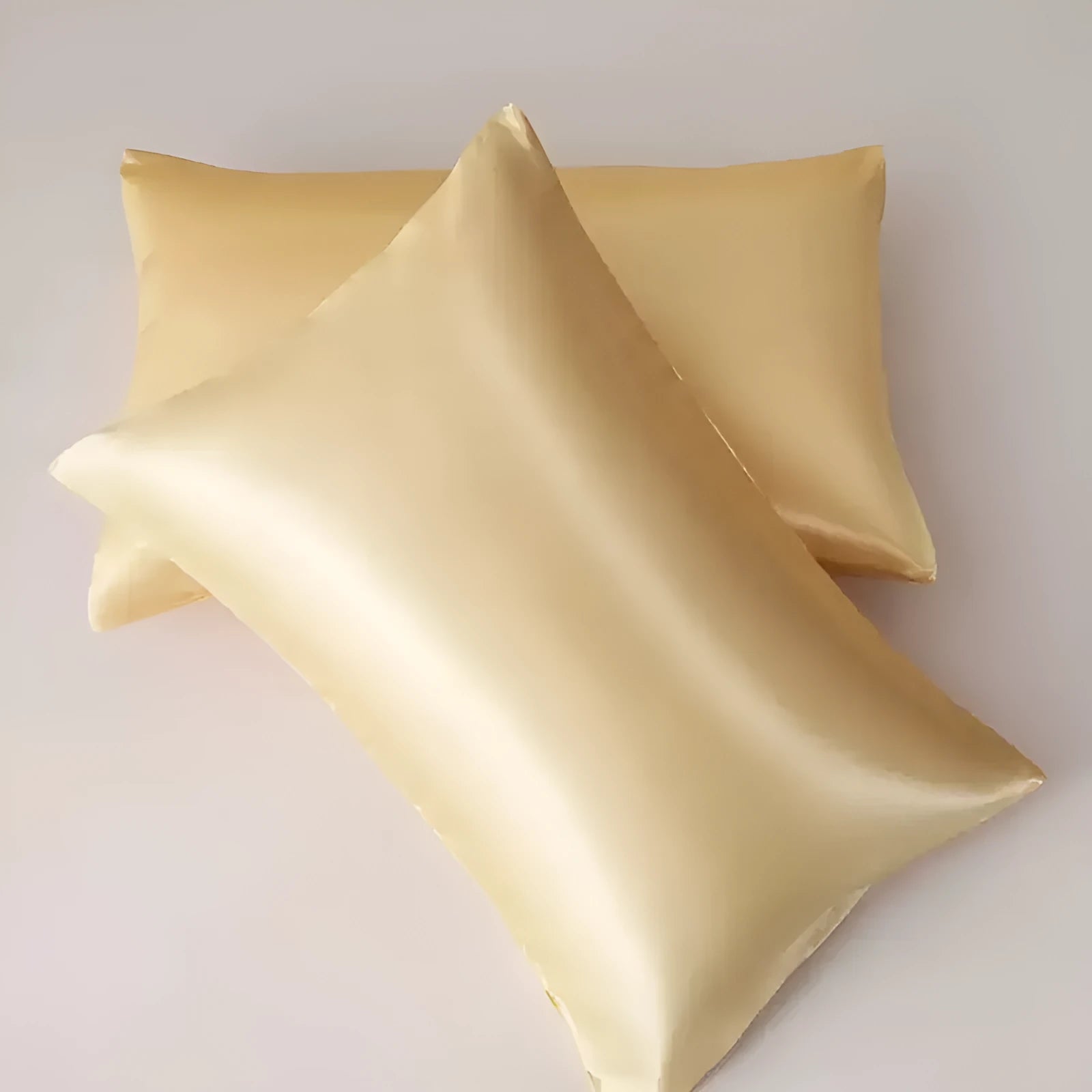 A pair of solid-colour satin cloth pillowcases in one of 13 available colours, shown in a standard pillow size.