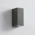 Modern black aluminium and glass LED wall sconce lamp mounted on a wall.