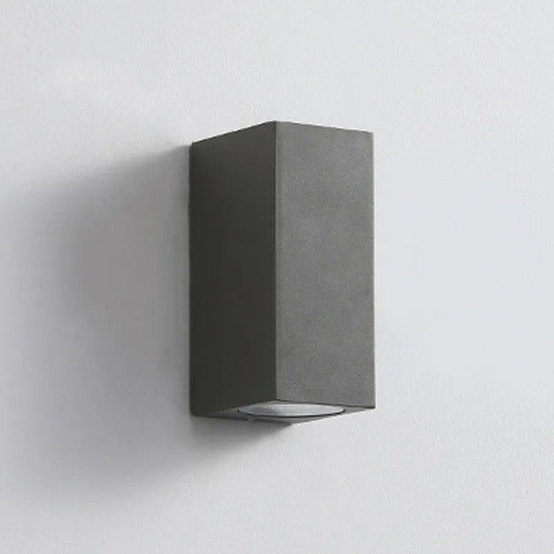 Modern black aluminium and glass LED wall sconce lamp mounted on a wall.