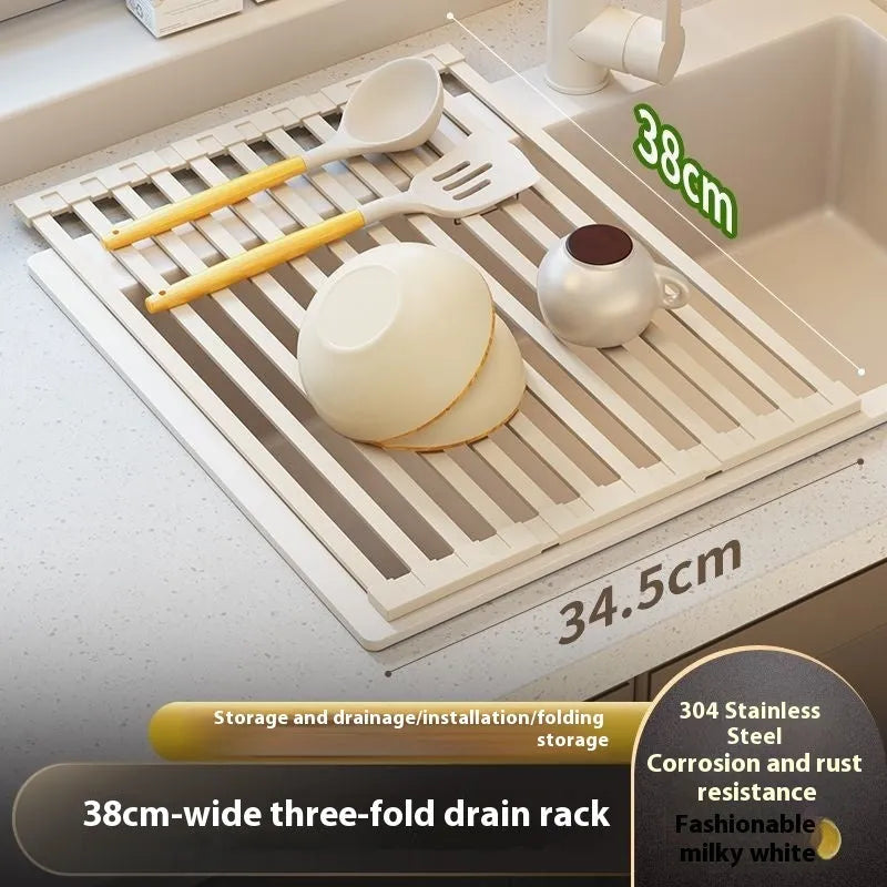 Milky White foldable stainless steel kitchen draining rack shown beside a sink, demonstrating its tri-fold mechanism.