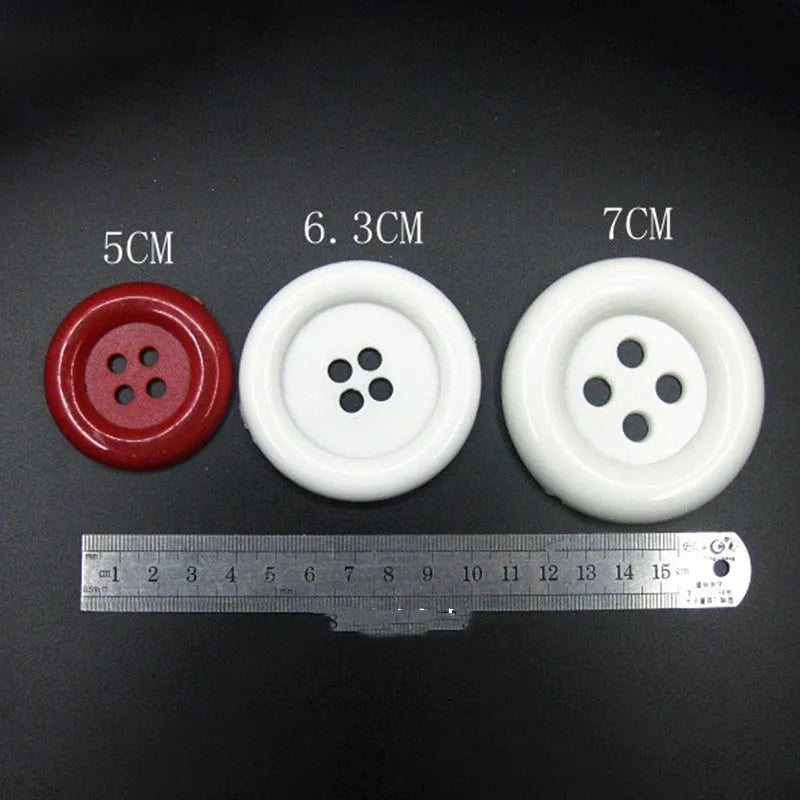 Oversized plastic round edge button with four holes in assorted colours and sizes